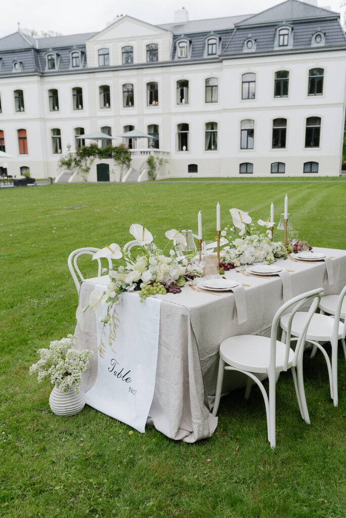 Elegant gedeckte Hochzeitstafel hinter dem Schloss des Weissenhaus Private Nature Luxury Resort an der Ostsee.